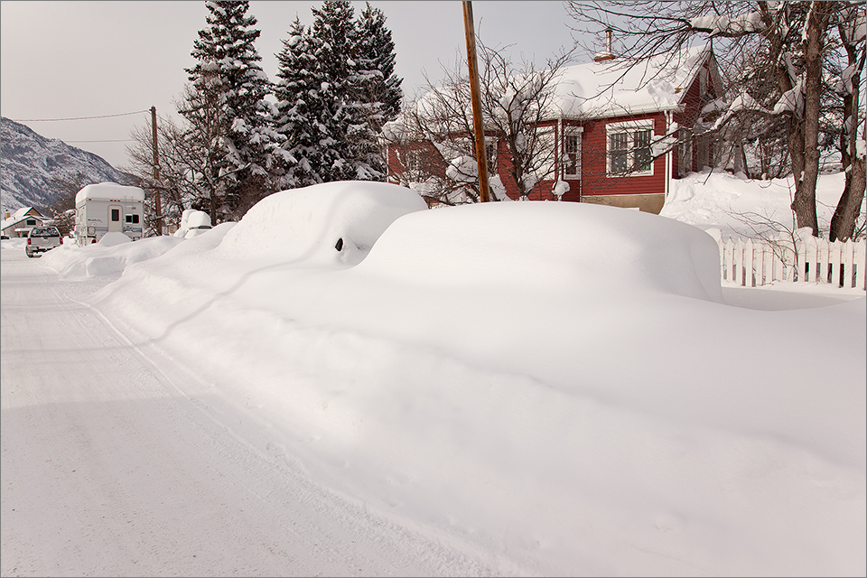 Another vehicle and trailer buried in snow