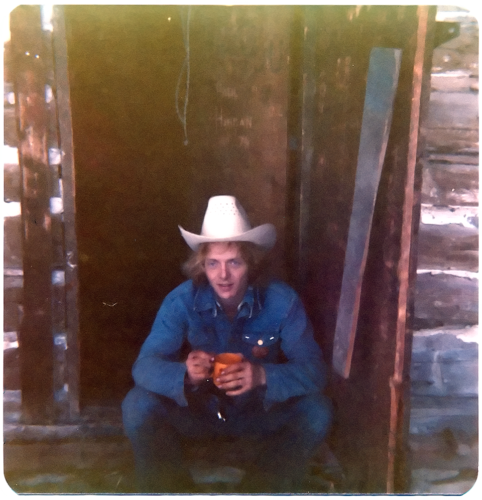 Enjoying a cup of coffee at the front door of the cabin ca. 1973 - 1975