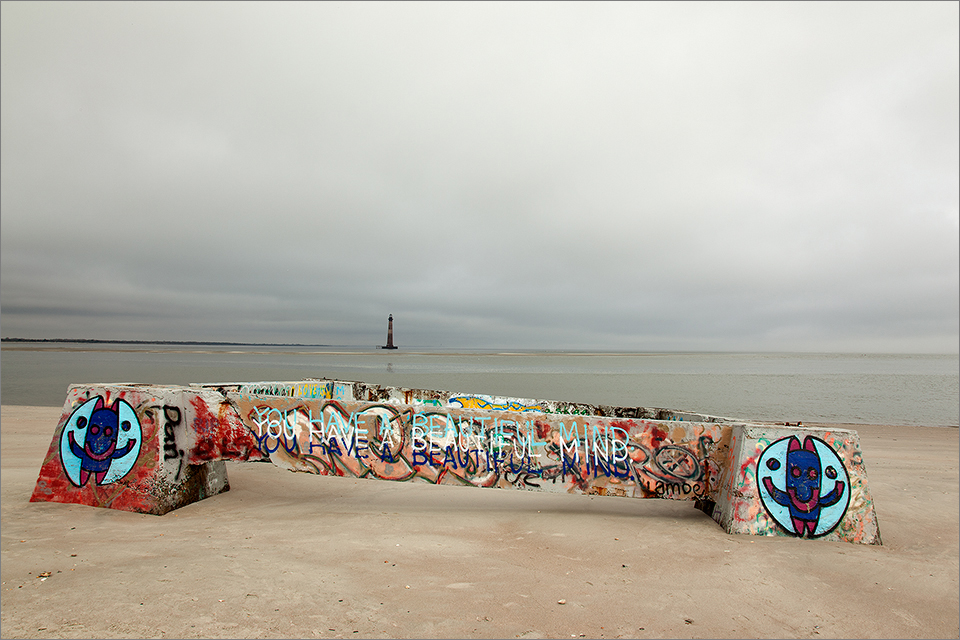 Concrete graffiti, with lighthouse in the distance